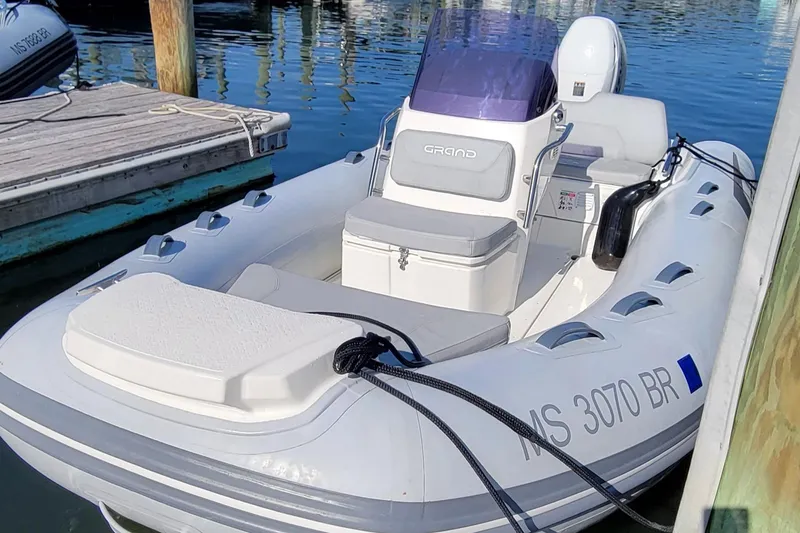 Slide: The Image of 2021 Grand Inflatables G420 boat docked in marina. - 2