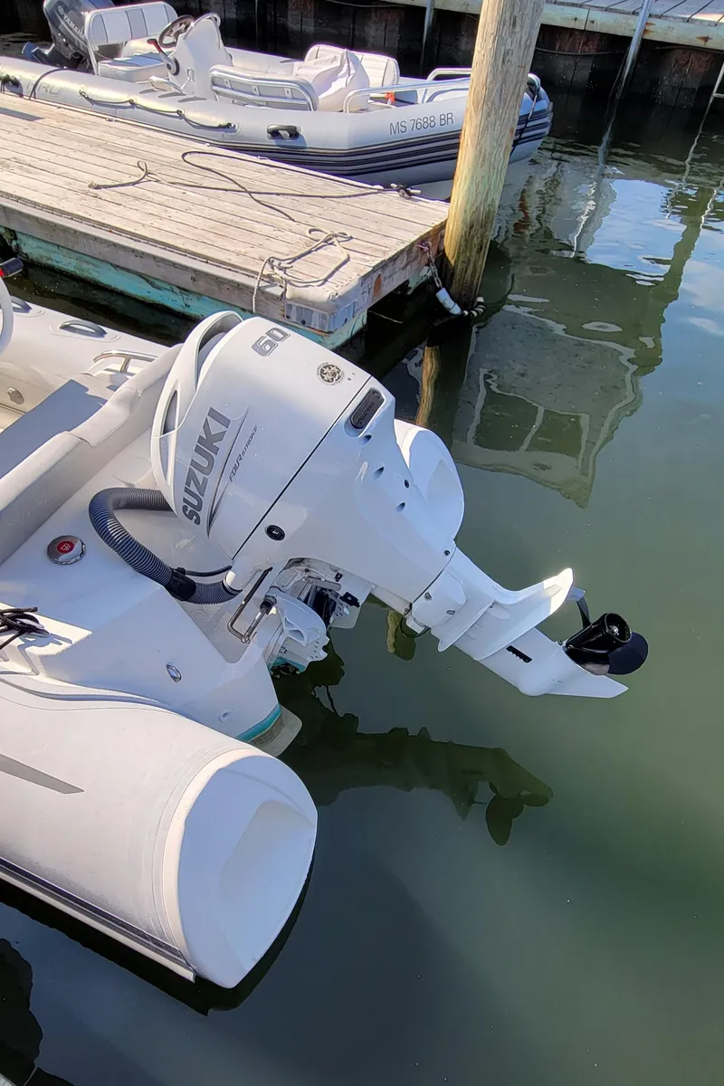 Slide: The Image of 2021 Grand Inflatables G420 boat with Suzuki outboard motor docked in marina. - 3