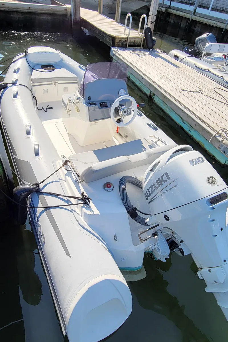 Slide: The Image of 2021 Grand Inflatables G420 boat with Suzuki 60 outboard motor docked at marina. - 4