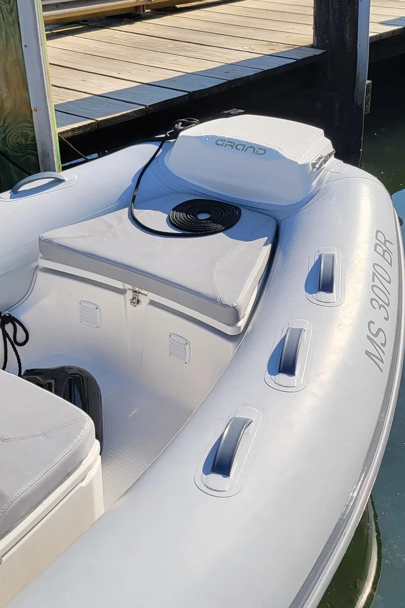 Slide: The Image of 2021 Grand Inflatables G420 boat docked, featuring sleek design and comfortable seating. - 5