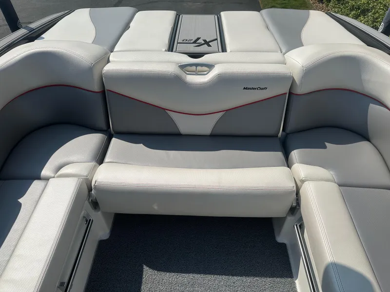 Slide: The Image of Interior of a 2017 MasterCraft XT20 boat with gray upholstery. - 14