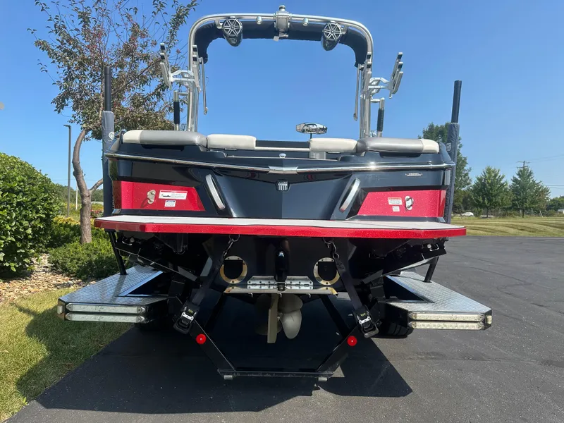 Slide: The Image of Rear view of a 2017 MasterCraft XT20 boat on asphalt. - 5