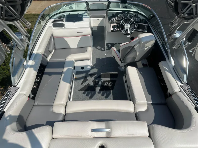 Slide: The Image of Interior of a 2017 MasterCraft XT20 boat with gray and white seating. - 9