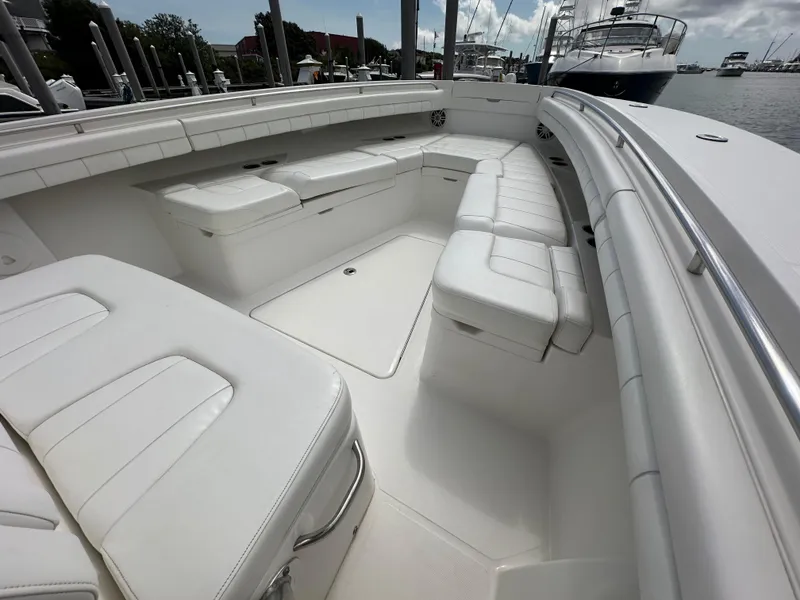 Slide: The Image of 2017 Regulator 31 boat with spacious white seating in a marina setting. - 11