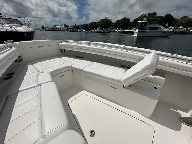 Slide: The Image of 2017 Regulator 31 boat with white seating, docked in a marina under cloudy skies. - 12