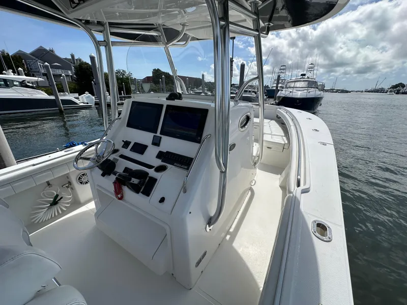 Slide: The Image of 2017 Regulator 31 boat interior with helm, docked in marina. - 14