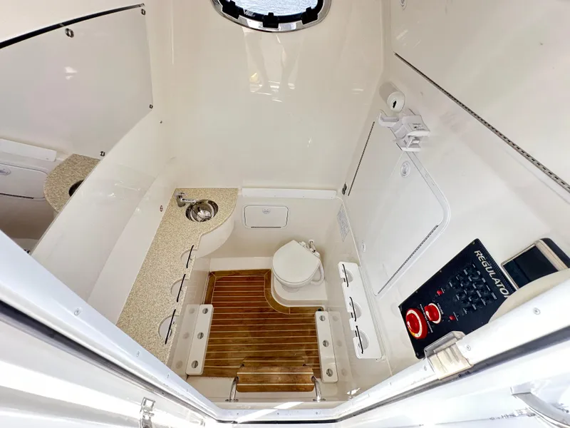 Slide: The Image of 2017 Regulator 31 boat interior with sink, toilet, and control panel. - 15