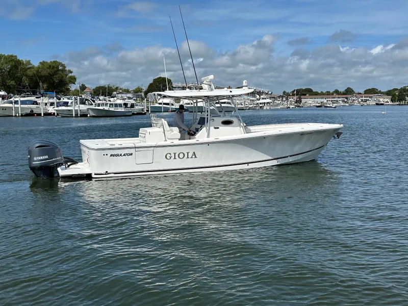 Slide: The Image of 2017 Regulator 31 boat on water with Yamaha engine, clear sky background. - 4