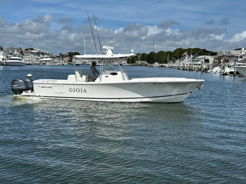 Slide: The Image of 2017 Regulator 31 boat "GIOIA" cruising in a marina under a clear sky. - 5