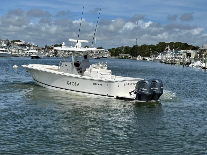 Slide: The Image of 2017 Regulator 31 boat "Gioia" with twin Yamaha engines in a marina. - 6
