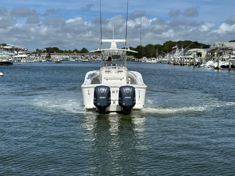Slide: The Image of 2017 Regulator 31 boat with dual Yamaha 300 engines in a marina setting. - 7