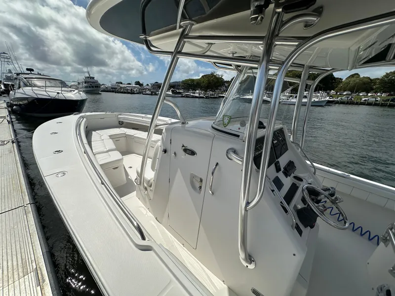 Slide: The Image of 2017 Regulator 31 boat docked at marina, featuring sleek design and spacious seating. - 8