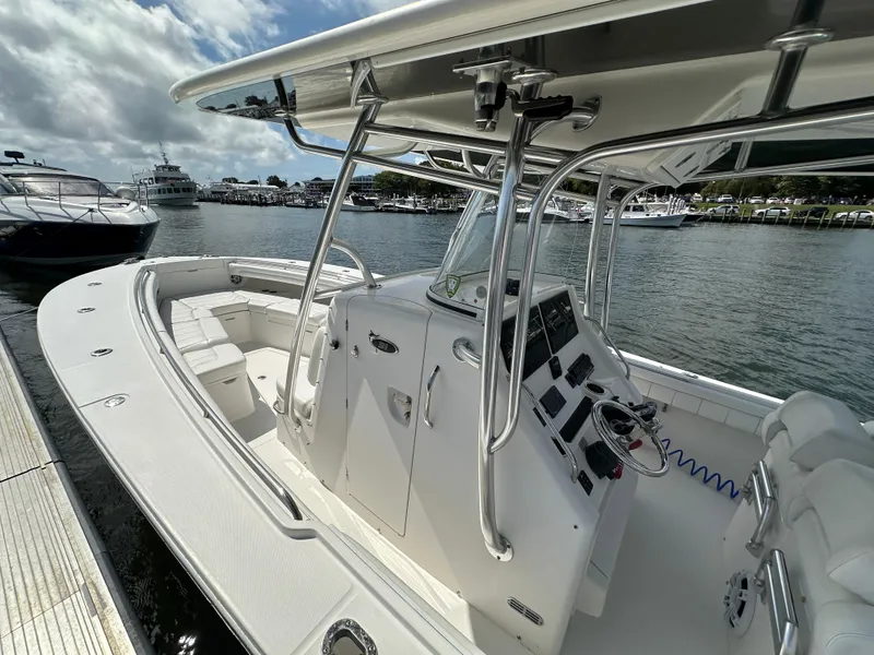 Slide: The Image of 2017 Regulator 31 boat docked, featuring spacious seating and modern controls. - 9