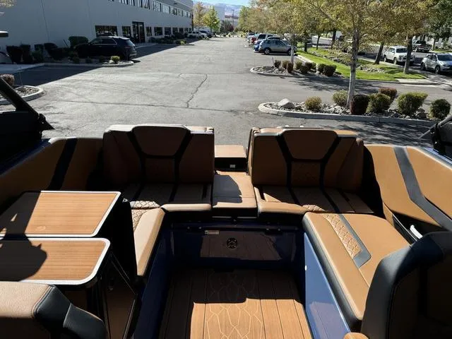 Slide: The Image of 2024 Yamaha Boats 255XD interior with luxurious seating and modern design in a parking lot setting. - 11