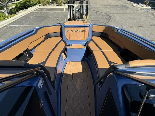 Slide: The Image of 2024 Yamaha Boats 255XD interior with tan seating and sleek design. - 4