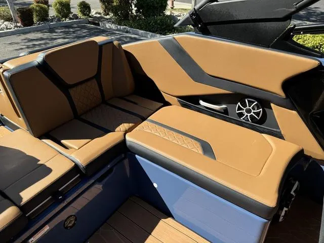 Slide: The Image of 2024 Yamaha Boats 255XD interior with tan and black seating, modern design. - 7