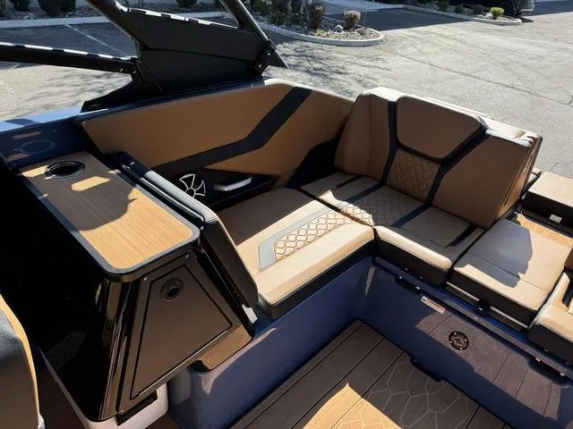 Slide: The Image of Luxurious interior of 2024 Yamaha Boats 255XD with tan seating and sleek design. - 9