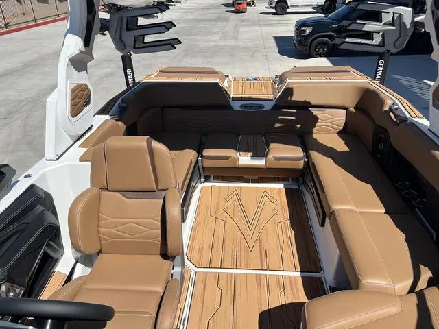 Slide: The Image of 2025 Supra SA 450 boat interior with tan leather seats and wood flooring. - 10