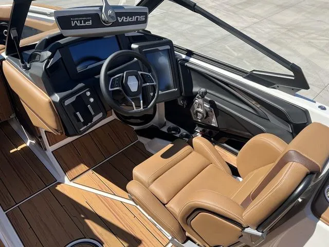 Slide: The Image of Luxurious 2025 Supra SA 450 boat interior with advanced dashboard and tan leather seating. - 12