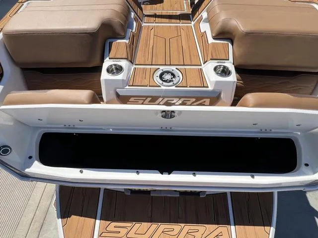 Slide: The Image of 2025 Supra SA 450 boat interior with brown seating and wood accents. - 16