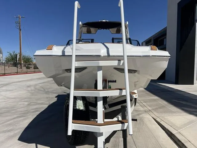 Slide: The Image of 2025 Supra SA 450 boat on trailer, rear view with ladder, sunny day. - 3