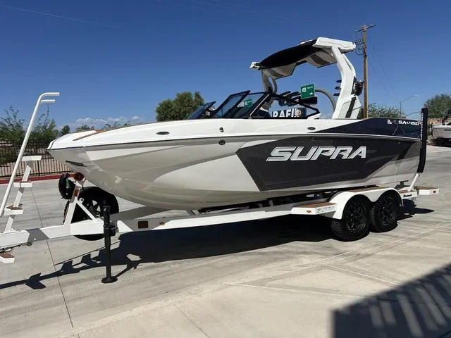 Slide: The Image of 2025 Supra SA 450 boat on trailer, sleek design, parked outdoors. - 4