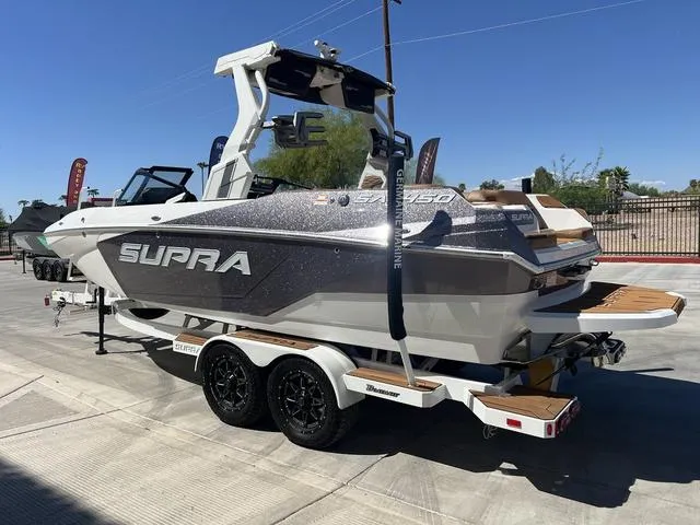Slide: The Image of 2025 Supra SA 450 boat on trailer, sleek design, outdoor display. - 6