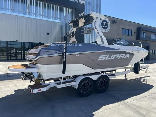 Slide: The Image of 2025 Supra SA 450 boat on trailer, parked outside modern building. - 8