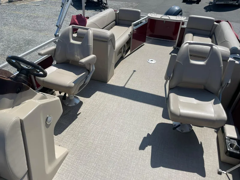 Slide: The Image of 2021 Avalon GS Cruise 23' pontoon boat interior with beige seating and steering console. - 15