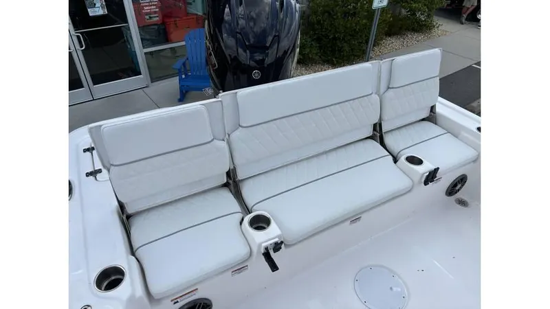 Slide: The Image of 2025 Sea Fox 251 Bay Fox boat with white cushioned seating and cup holders. - 12