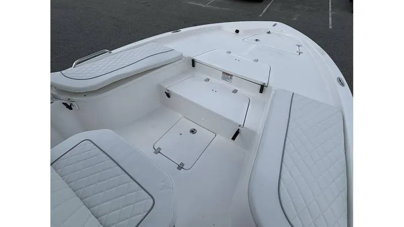 Slide: The Image of 2025 Sea Fox 251 Bay Fox boat interior with cushioned seating and storage compartments. - 7