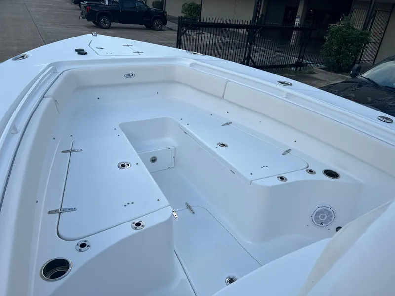 Slide: The Image of 2024 Sea Hunt Gamefish 27 FS boat interior, spacious deck with storage compartments. - 12