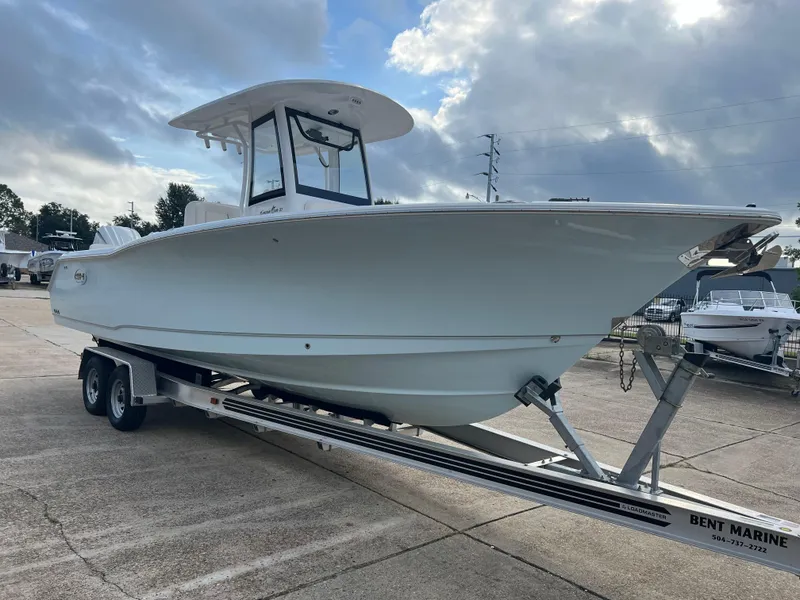 Slide: The Image of 2024 Sea Hunt Gamefish 27 FS boat on trailer under cloudy sky. - 3