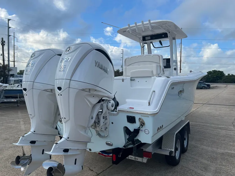 Slide: The Image of 2024 Sea Hunt Gamefish 27 FS boat with dual Yamaha engines on trailer. - 7