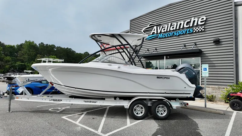 The Image of 2025 Sea Fox 228 Traveler boat on trailer at Avalanche Motorsports dealership. - 1