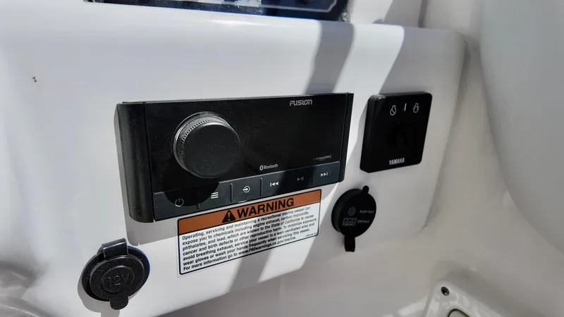 Slide: The Image of Control panel of 2025 Sea Fox 228 Traveler boat with warning label and audio system. - 10