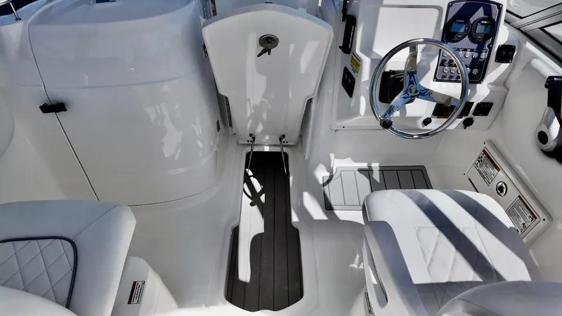 Slide: The Image of 2025 Sea Fox 228 Traveler boat interior with steering wheel and seating. - 18