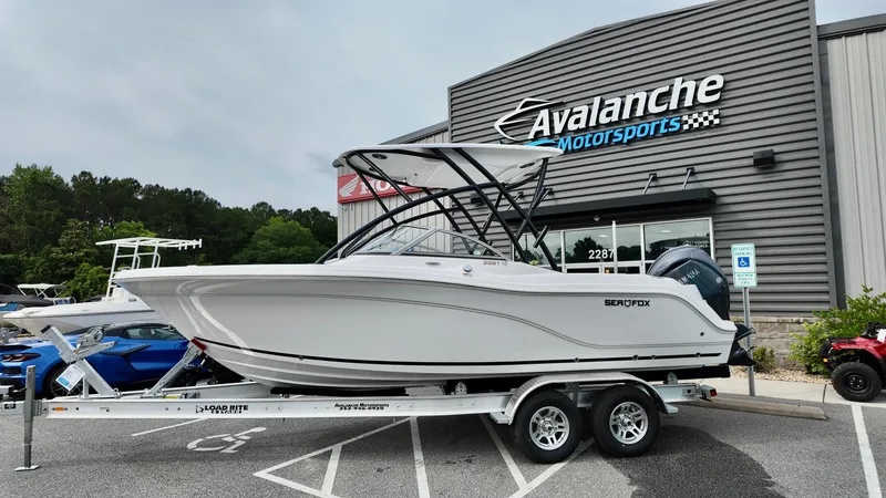 Slide: The Image of 2025 Sea Fox 228 Traveler boat on trailer at Avalanche Motorsports dealership. - 2