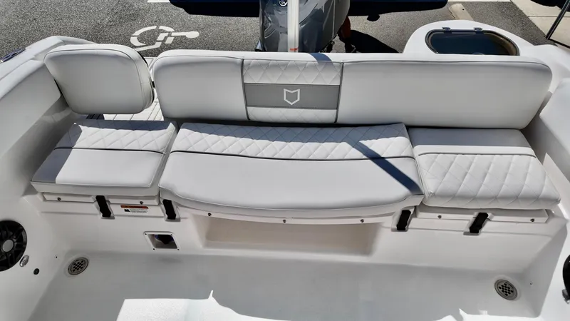 Slide: The Image of 2025 Sea Fox 228 Traveler boat seating area with cushioned bench and storage compartments. - 6