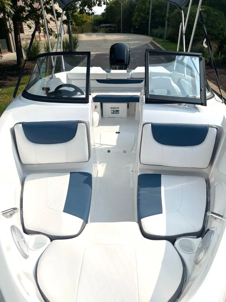 Slide: The Image of 2024 Tahoe 200 S boat interior with blue and white seating, open deck layout. - 2