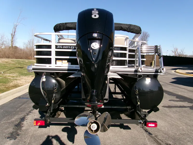 Slide: The Image of 2024 Ranger Reata 220F pontoon boat with powerful outboard motor, parked on a trailer. - 2