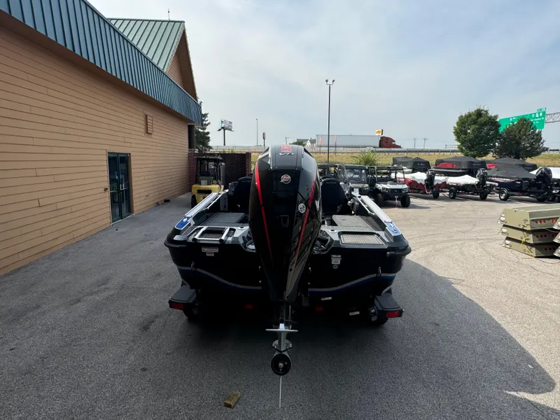 Slide: The Image of 2024 Nitro ZV20 boat with powerful outboard motor in a parking lot. - 2