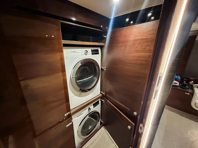 Slide: The Image of Laundry area with stacked washer and dryer in a 2020 Princess 78 yacht. - 10