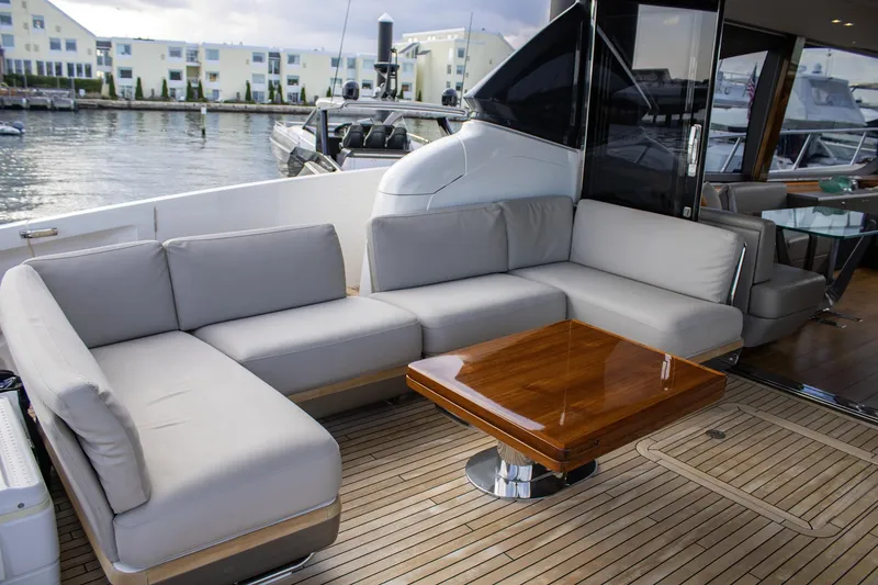 Slide: The Image of Luxurious 2020 Princess 78 yacht with elegant outdoor seating and wooden table. - 17