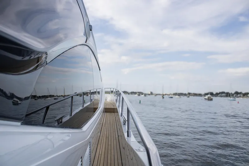 Slide: The Image of Sleek 2020 Princess 78 yacht cruising on calm waters under a cloudy sky. - 19