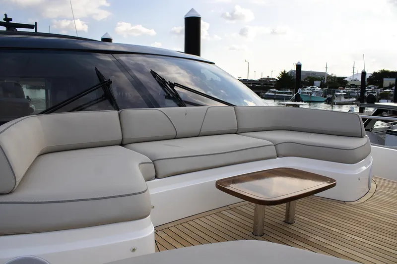Slide: The Image of Luxurious seating area on 2020 Princess 78 yacht, featuring elegant design and marina backdrop. - 20
