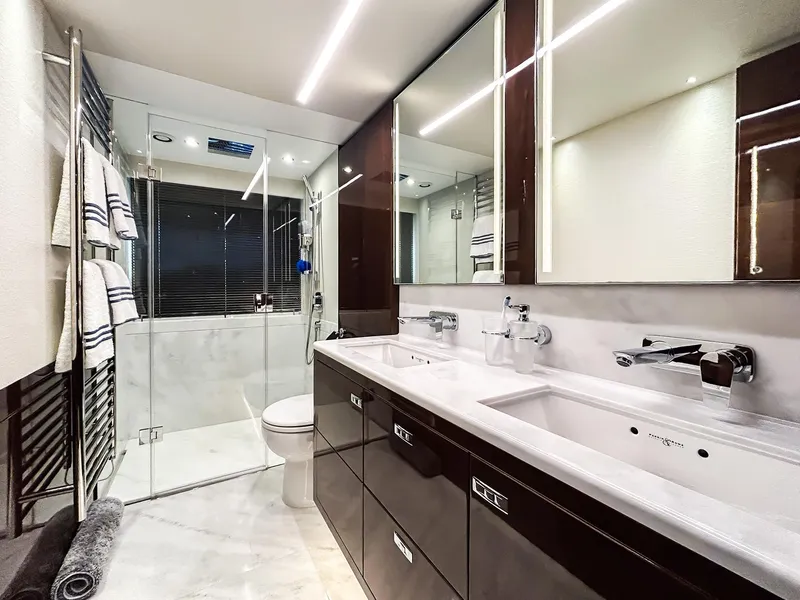 Slide: The Image of Luxurious yacht bathroom with dual sinks, glass shower, and modern fixtures, Princess 78, 2020 model. - 9