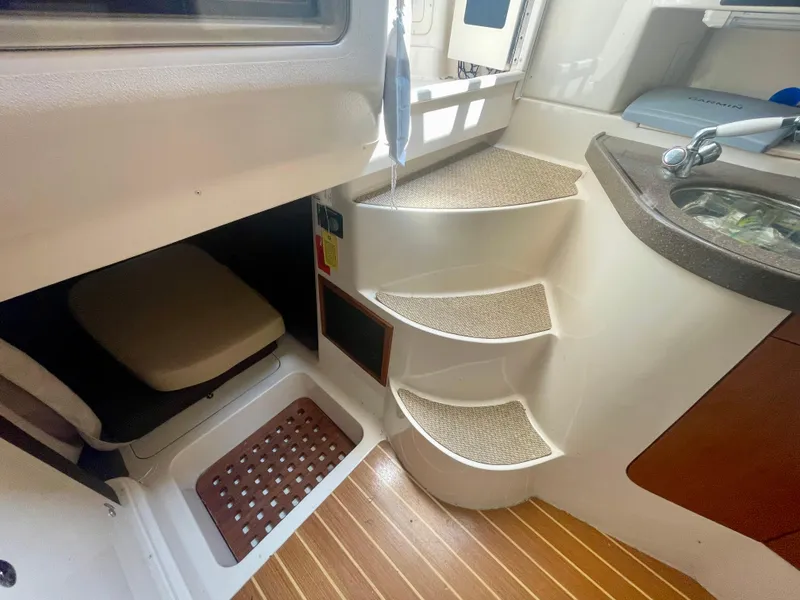 Slide: The Image of Interior of 2009 Grady-White 330 Explorer boat with steps and compact cabin space. - 10