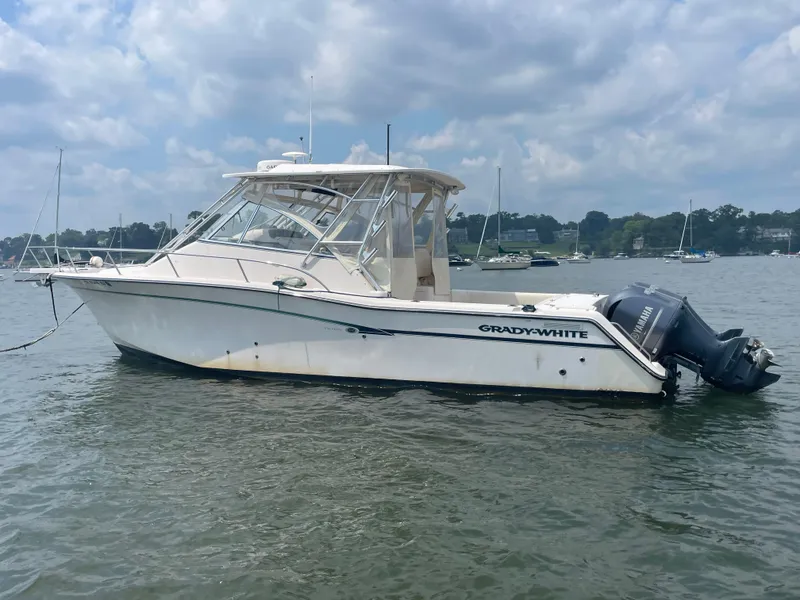 Slide: The Image of 2009 Grady-White 330 Explorer boat on calm water under cloudy sky. - 15
