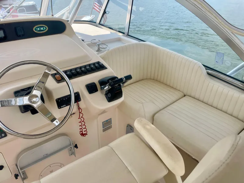 Slide: The Image of 2009 Grady-White 330 Explorer boat interior with steering wheel and seating. - 2